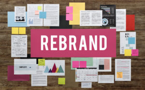 Mood board with a large post-it note that reads "Rebrand"